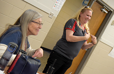  Casey Nall teaches sign language during at staff meeting at PHS.